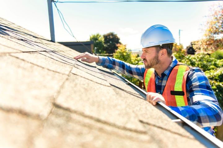 roof inspector performing routine roof inspection